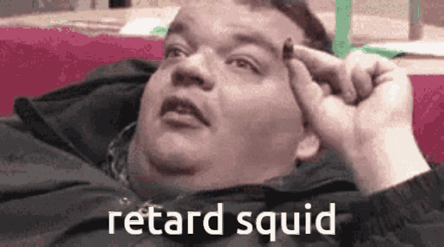 a fat man is laying on a couch with his hand on his forehead and the words retard squid written above him .