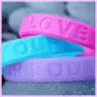 three bracelets stacked on top of each other with the word love on them