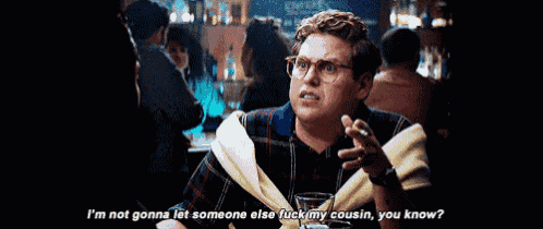 a man with glasses is sitting at a table with a glass of wine and says i 'm not gonna let someone else
