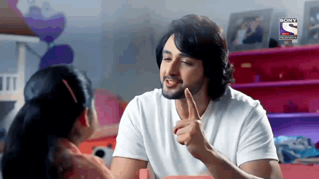 a man in a white shirt is talking to a little girl in a sony tv ad
