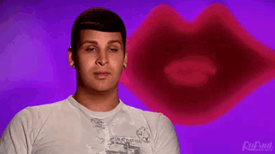 a man is standing in front of a large red lip .