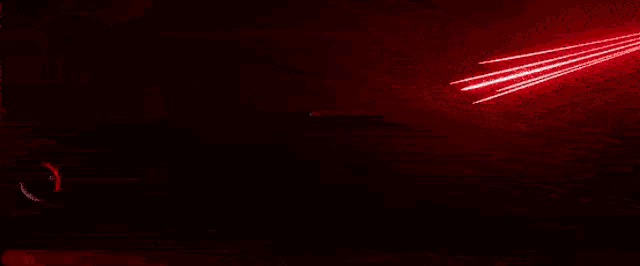 a person standing in front of a large red light