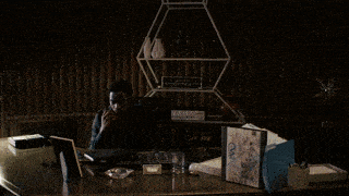 a blurry picture of a person standing in a dark room .