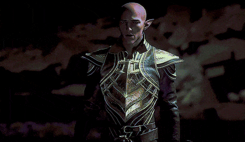 a bald man with elf ears is wearing a black and gold armored outfit