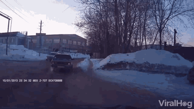 a car is driving down a snowy road with the date 10/01/2013 on the bottom