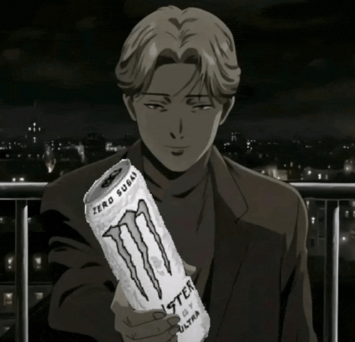 a man in a suit holds a can of monster energy drink
