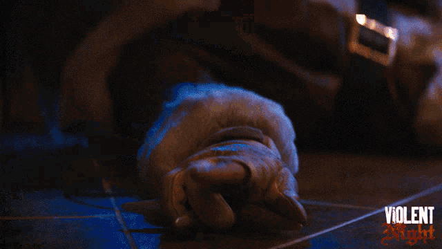 a hand is pressing a button with the words violent night on the bottom