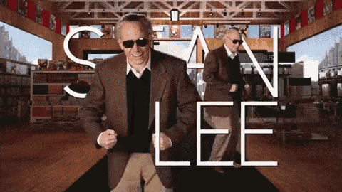 a man in a suit and sunglasses is dancing in front of a sign that says " stan lee "