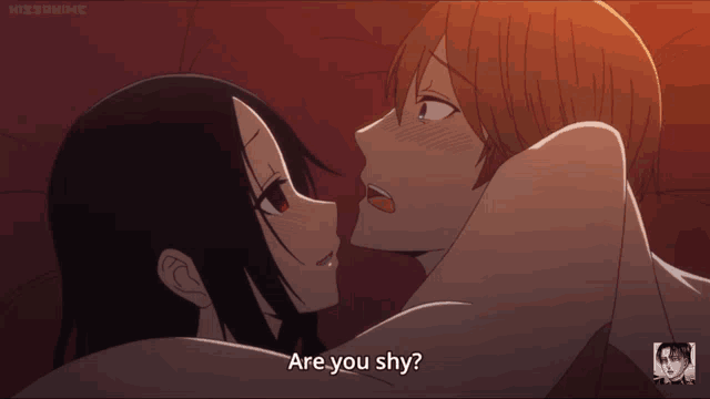 a man and a woman are kissing and the man is asking the woman if she is shy