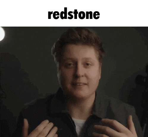a man making a funny face with the word redstone behind him