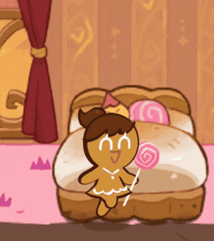 a gingerbread girl is sitting on a bed with a lollipop