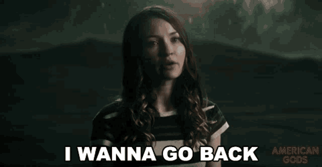 a woman is saying " i wanna go back " in a dark room