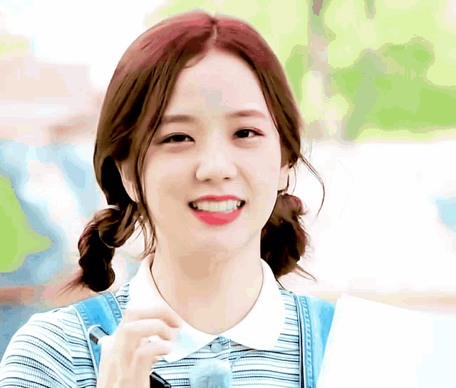 a girl with pigtails and overalls smiles for the camera with the word girl on the bottom right corner