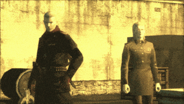 a man and a woman are standing next to each other in front of a stone wall