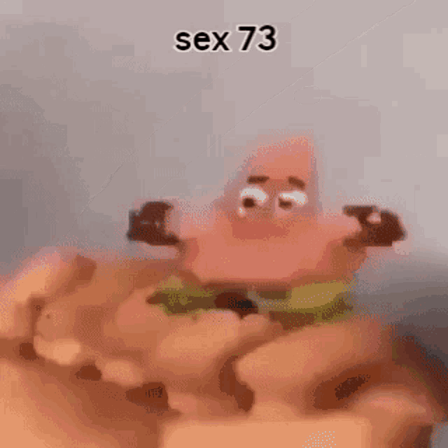 patrick star from spongebob squarepants is being held in a hand .