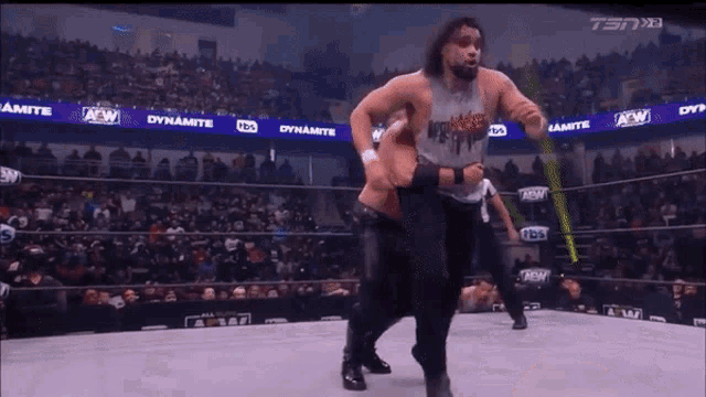 a wrestling match is being shown on a television screen