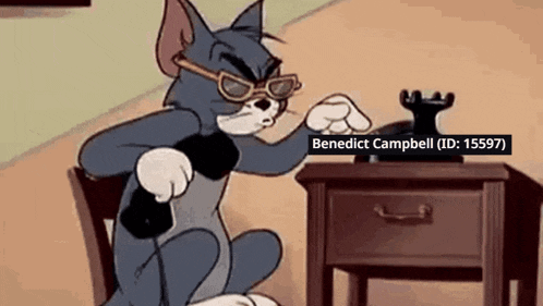a cartoon cat wearing sunglasses is sitting at a table with a phone .