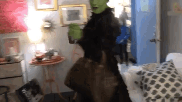 a person in a mask is dancing in a room