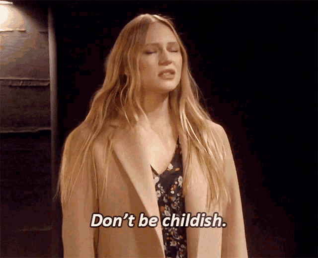 a woman in a tan coat is saying " don 't be childish "