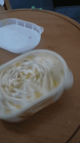 a container of ice cream sits on a table