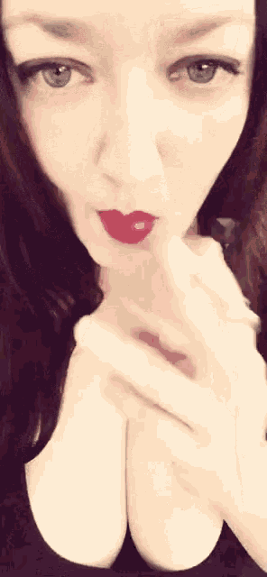 a close up of a woman 's face with red lipstick on