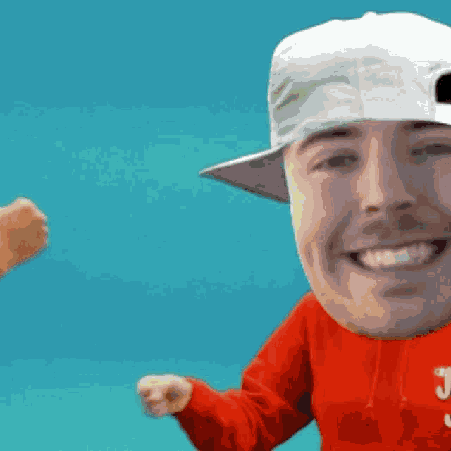 a man wearing a white hat and a red sweatshirt with the letter j on it is smiling