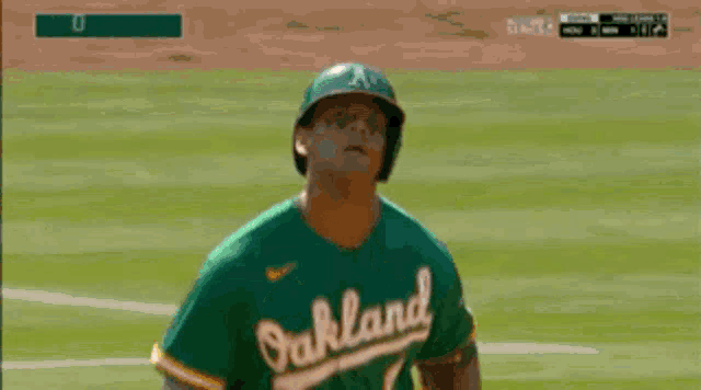 a baseball player in a green jersey with the number 2 on the back
