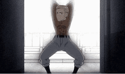 a man is standing in front of a window with his arms outstretched and his legs crossed .