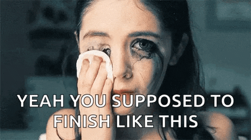 a girl is crying and wipes her eyes with a cotton pad .