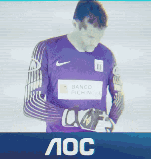 a man wearing a purple nike jersey with a banco pichincha logo