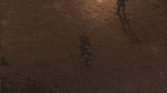 a statue of a man is laying on a brick floor