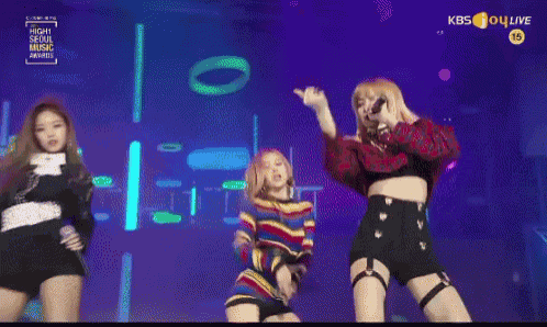 three women are dancing on a stage with a kbs live logo in the background