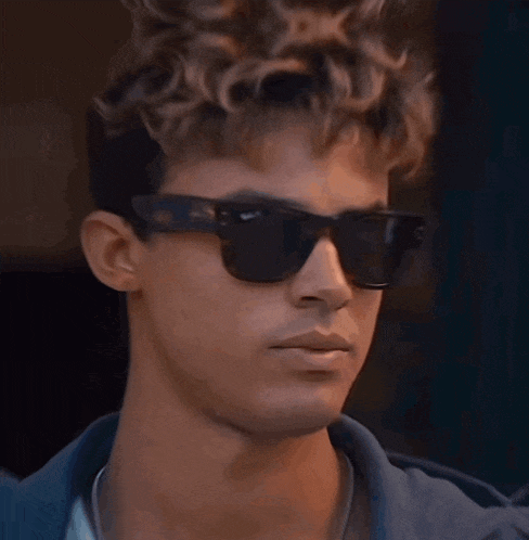 a close up of a man wearing sunglasses