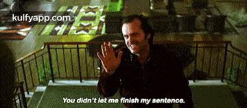 a man is standing on a balcony with his hands up and says you didn 't let me finish my sentence .