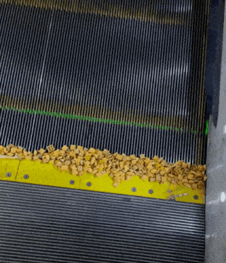 a close up of an escalator with a yellow border