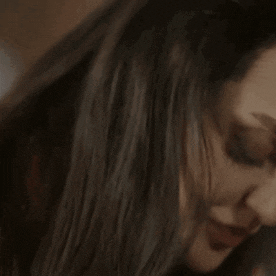 a close up of a woman 's face with her eyes closed and red lips