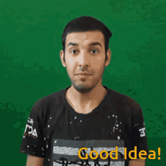 a man in a black t-shirt is pointing up with the words good idea behind him