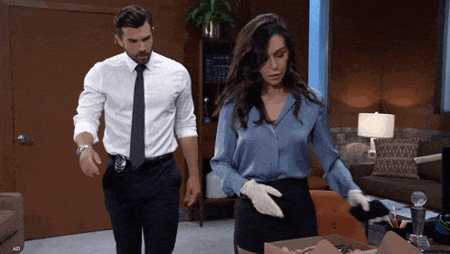 a man and a woman standing next to each other in an office