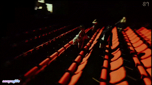a row of red seats in an empty auditorium with the letters s on the bottom