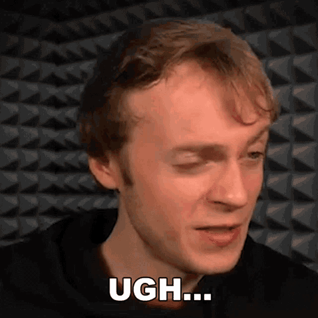 a close up of a man 's face with the words " ugh " written on it
