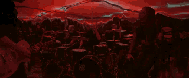 a man is playing a guitar in a dark room
