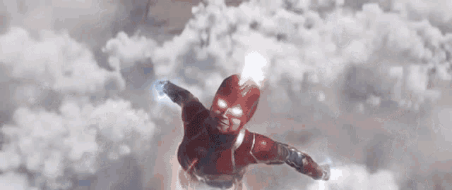 captain marvel is flying through the air in a superhero costume .