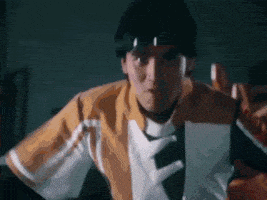 a man is holding a piece of paper in his hand and wearing a headband .