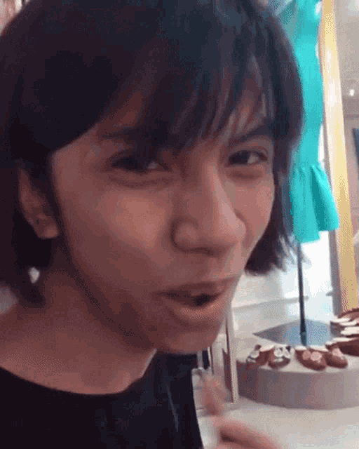 a woman with short hair is making a funny face in front of a display of shoes