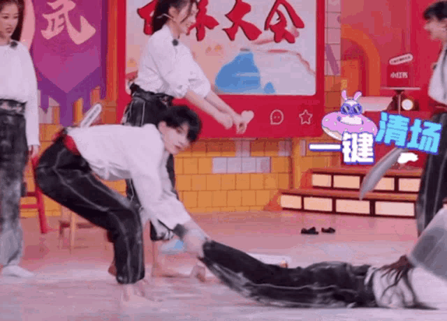 a group of people are playing a game in front of a sign with chinese writing