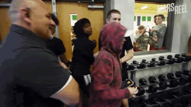 a group of people in a gym with the word mars reel on the bottom left