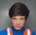 a young man wearing a blue shirt and orange vest
