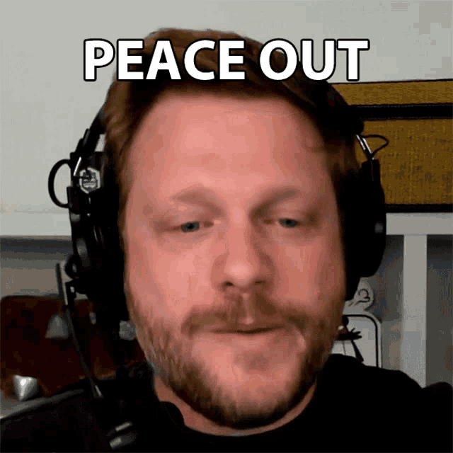 a man wearing headphones with a peace out sign above his head