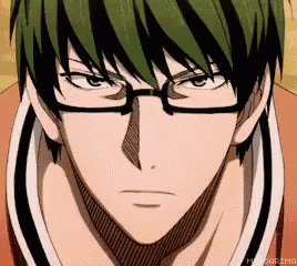 a close up of a man with green hair and glasses .