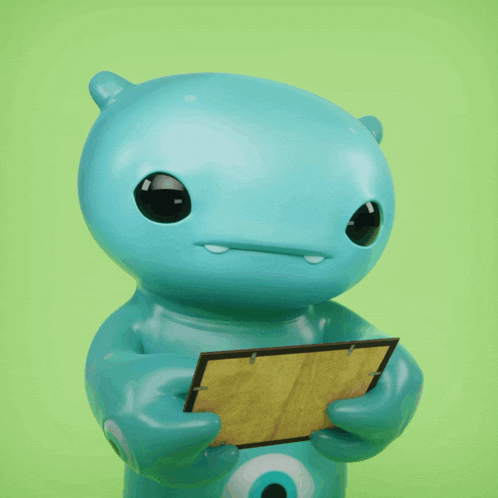 a blue monster is holding a picture frame in its hands